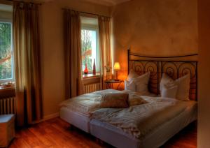 a bedroom with a large bed and a window at Alte Brauerei Kasbachtal in Kasbach-Ohlenberg