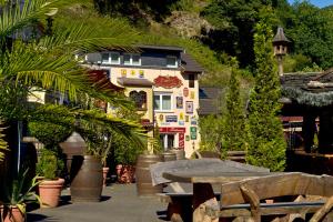a building with a table and plants in front of it at Alte Brauerei Kasbachtal in Kasbach-Ohlenberg