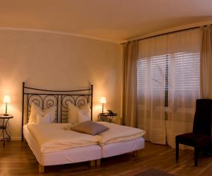 a bedroom with a bed and a large window at Alte Brauerei Kasbachtal in Kasbach-Ohlenberg