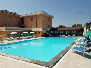 una gran piscina con tumbonas y un hotel en Hotel Trasimeno Bittarelli, en Castiglione del Lago