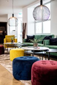 a living room with couches and tables and chairs at 201 Hotel in Reykjav&iacute;k