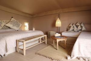 
Ein Bett oder Betten in einem Zimmer der Unterkunft Terre Des Etoiles

