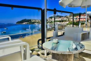 a table and chairs with a view of the water at Os Salguieiros (the Willows) in Pontevedra