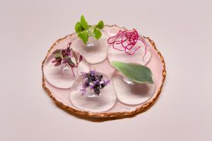 a plate with some plants on top of it at The Langham London in London