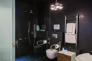 a bathroom with a shower and a toilet and a sink at Baps Apartments in Bilbao