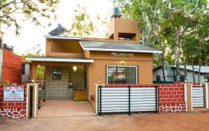 ein Haus mit einem Tor davor in der Unterkunft Shri Laxmi Narayan Bungalow in Mahabaleshwar