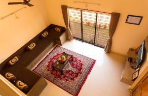 an overhead view of a living room with a table at Shri Laxmi Narayan Bungalow in Mahabaleshwar