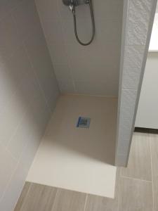 a bathroom with a shower with a drain in the floor at Aloe New Excellence in Playa del Ingles