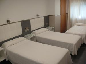 Posteľ alebo postele v izbe v ubytovaní Hostal La Hispanidad