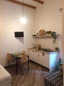 a kitchen and dining room with a table and a counter at Casa Vittoria in Salerno