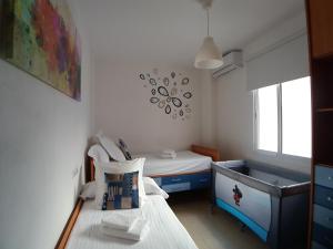 サンルーカル・デ・バラメダにあるApartamento Reinaのベッド1台とシンク付きの小さな客室です。