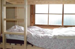 a bedroom with two bunk beds and a window at Satoyama Guest House Couture in Ayabe