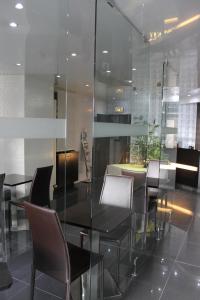 a dining room with a black table and chairs at Hotel The Originals du Grand Monarque Nantes Gare in Nantes