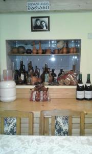 a table with a bunch of bottles on a shelf at Guesthouse Valeria in Borjomi