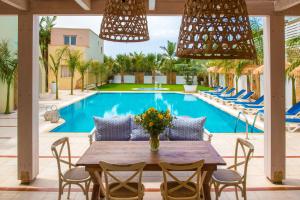 a patio with a table and chairs and a pool at Danaides in Malia