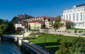 a group of buildings next to a river at Hotel D. Dinis in Leiria