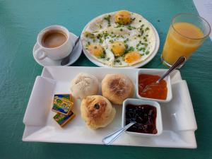 a plate of breakfast food and a cup of coffee at Maison Augustin LY in Gorée