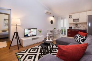 a living room with a couch and a tv at Apartment Toni Relax in Split