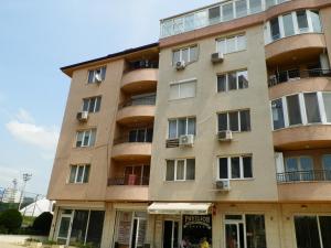 een hoog gebouw met ramen en balkons bij Cocoa Apartment in Varna