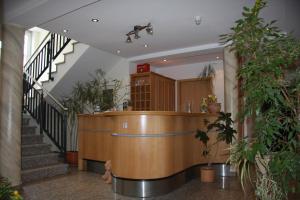 a lobby with stairs and a reception desk in a building at Hotel Gasthof Grüner Wald in Hofheim am Taunus