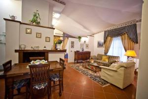 a living room with a table and a couch at Villa Rossana in Cenaia
