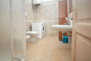 a bathroom with a toilet and a sink at Fronte Mare Capo Testa in Santa Teresa Gallura +26 photos