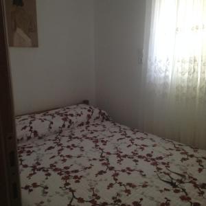 a bedroom with a bed with a floral bedspread at Kelly's studio SISAMOS in Karpathos