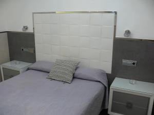 Posteľ alebo postele v izbe v ubytovaní Hostal La Hispanidad