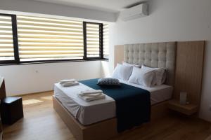 a bedroom with a bed with two towels on it at Hotel Active Apartments in Targovishte