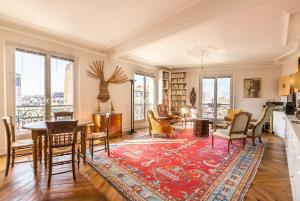 a living room with a table and chairs at Veeve - Classic Montparnasse in Paris