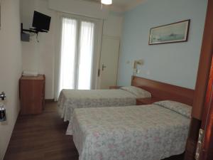 Postel nebo postele na pokoji v ubytování Hotel Liliana