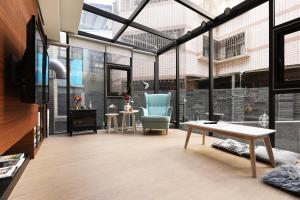 a living room with a couch and a table at Greenight Hotel in Taichung