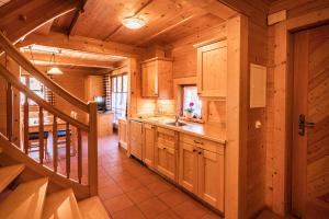 a kitchen with a staircase in a log cabin at Bauerndörfl Hüttschlag in Hüttschlag