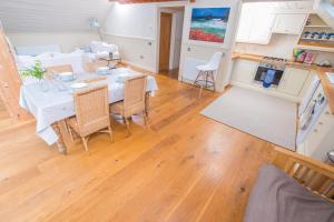 a kitchen and living room with a table and chairs at The Garden Studios in Budleigh Salterton +13 photos