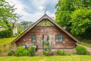 a small wooden house with a pointed roof at The Garden Studios in Budleigh Salterton