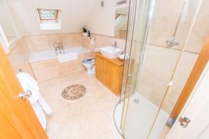 a bathroom with a shower and a sink and a toilet at The Garden Studios in Budleigh Salterton