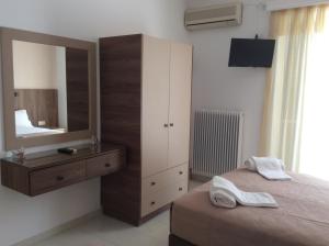 a bedroom with a mirror and a bed and a dresser at Erato Apartments in Petalidhion +81 photos