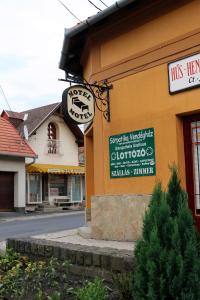 a building with a sign on the side of it at Sörpatika Vendégház in Badacsonytomaj
