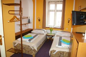 En eller flere senge i et værelse på Penzion Koudela