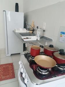 a kitchen with a stove with pots and pans on it at Apartamento no Dalas Park Residencial in Campina Grande
