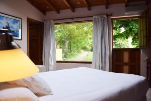 a bedroom with a bed and a large window at Hotel Hontoria in Hontoria