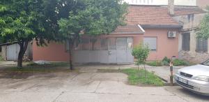 a house with a car parked in front of it at Cozy apartment in the center of Novi Sad! in Novi Sad