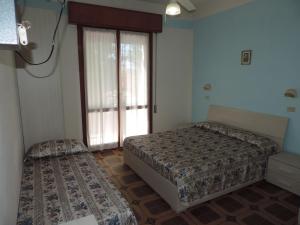 Postel nebo postele na pokoji v ubytování Hotel Liliana