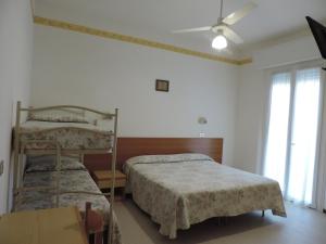 Postel nebo postele na pokoji v ubytování Hotel Liliana