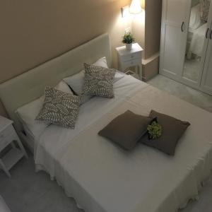 a white bed with pillows on it in a bedroom at Queen Chic Apartment in La Spezia