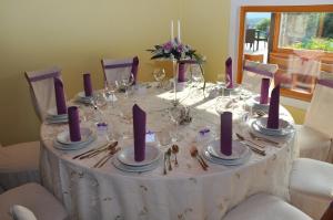 a table with purple candles on top of it at Guesthouse Dolinsek in Sevnica