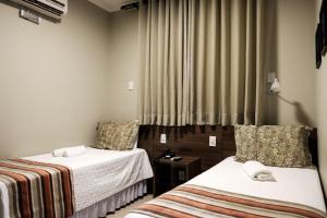 Säng eller sängar i ett rum på Ideali Hotel