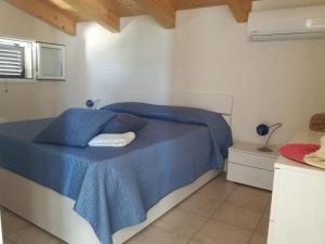 サンタ・マリア・デル・フォカッロにあるAppartamento Acaciaのベッドルーム(青いベッド1台、青い毛布付)