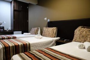 Postel nebo postele na pokoji v ubytování Ideali Hotel