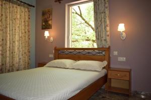 a bed in a room with a window and a bed sidx sidx sidx at Stamoulis Apartments in Agia Effimia